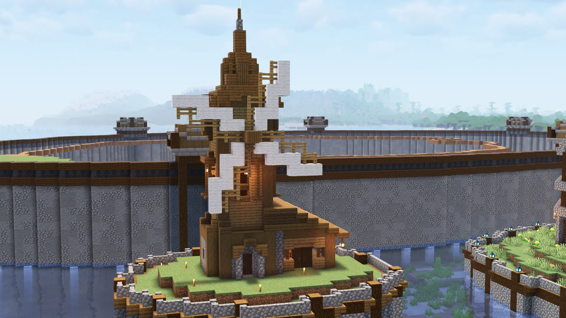 A simple spruce building with a white windmill stands alone on a small artificial island. Behind it is a much bigger island, also clearly artificial as shown by its completely vertical stone walls and wooden rim.