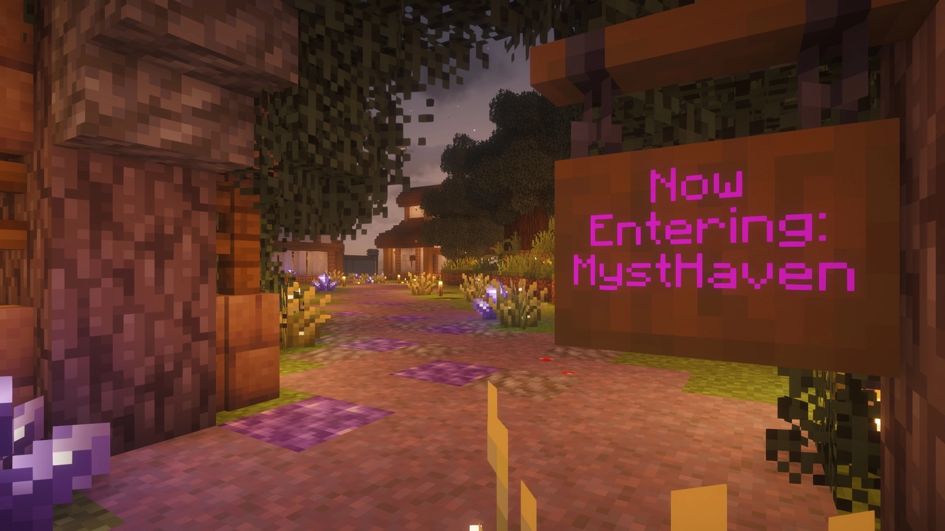Minecraft scene of a village entrance at sunset, with a path, trees, flowers, and a wooden sign that says “Now Entering: MystHaven” in pink text.